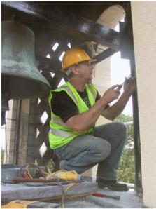 AIANO senior engineer Steve installing woven mesh window guards at the tower of St Anne's Church, Kew Green